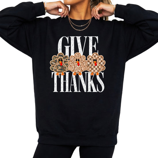 Give Thanks Thanksgiving sweatshirt for women in Black with camo, leopard and checkered turkeys