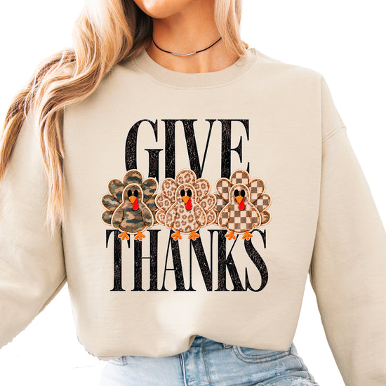 Give Thanks Thanksgiving sweatshirt for women in Sand with camo, leopard and checkered turkeys