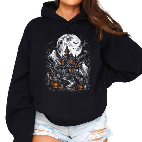Black haunted house Halloween hoodie for women with moonlit house, ghosts, black cat and jack-o-lanterns graphic
