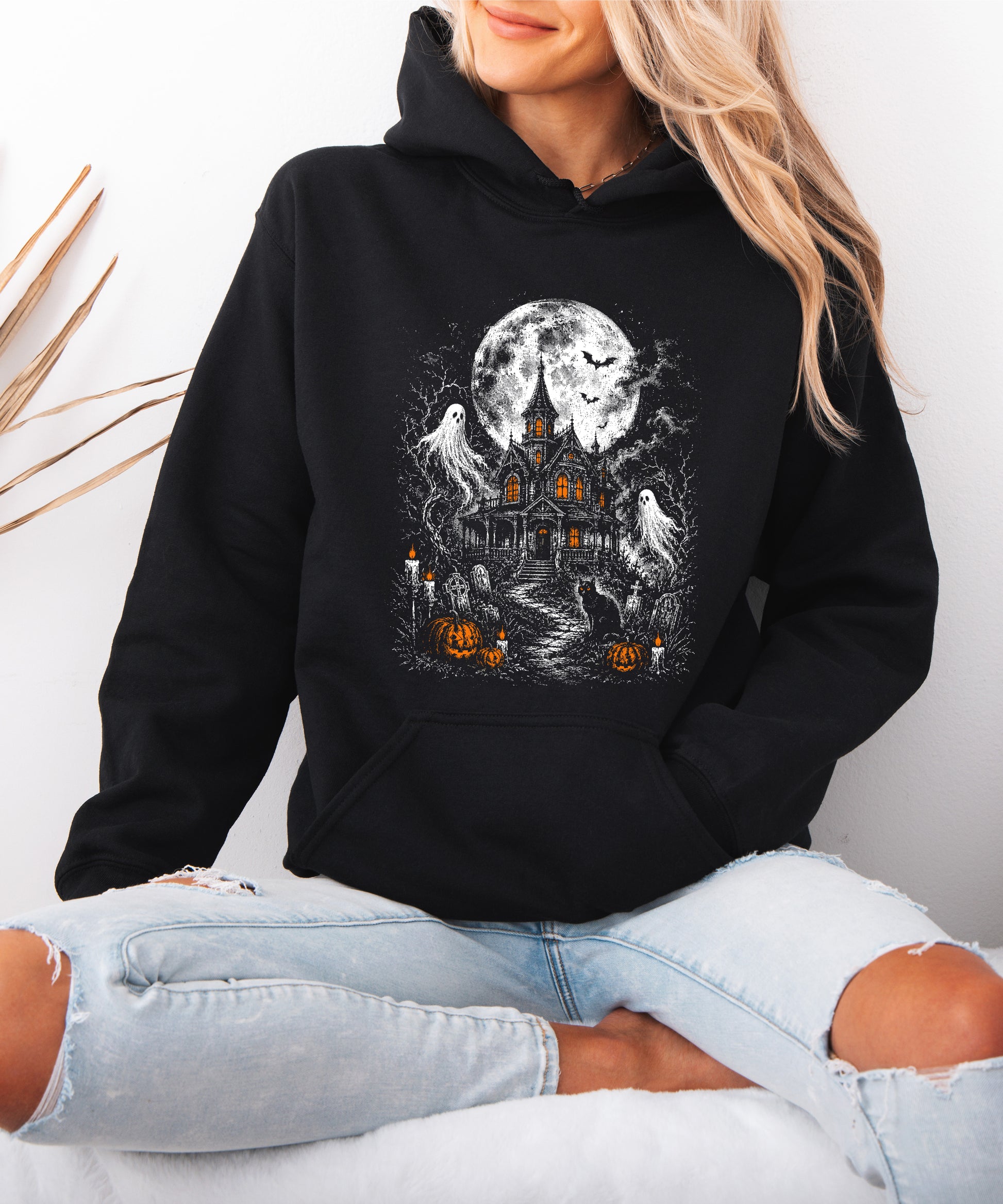 Black haunted house Halloween hoodie back and fit view, adult sizes small to XL