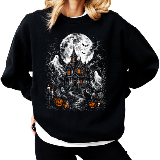 Moonlit graveyard and haunted house print detail on black Halloween crewneck sweatshirt