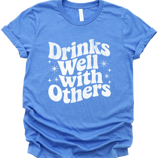 Drinks Well With Others funny graphic tee for women in Heather Blue, lifestyle view