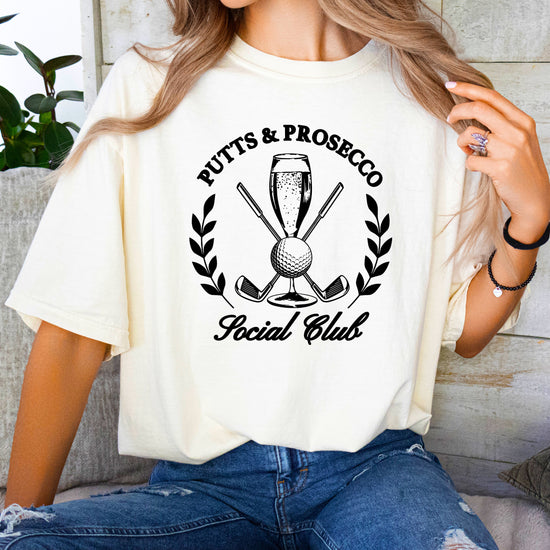 Putts and Prosecco Social Club womens golf tee in Ivory, lifestyle view