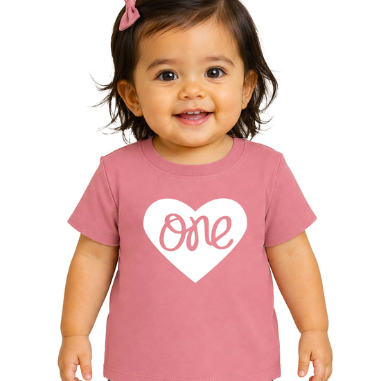 One in a Heart girls first birthday shirt, White on Mauve, main product photo