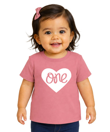 One in a Heart girls first birthday shirt, White on Mauve, main product photo