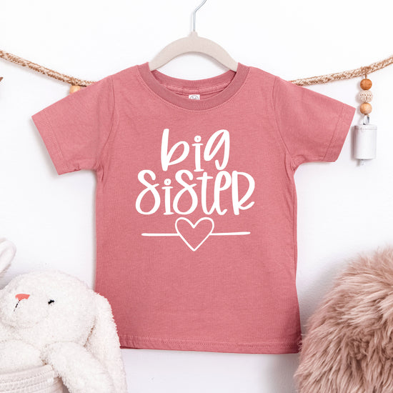 Big Sister heart sibling reveal t-shirt in white on mauve, second view