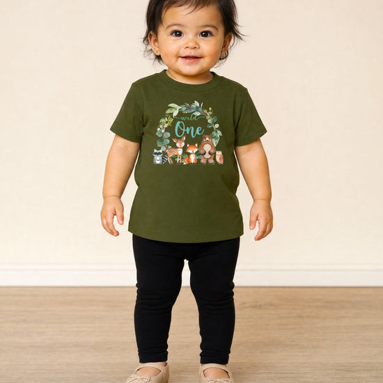 Close-up of Wild One woodland wreath design on military green baby tee