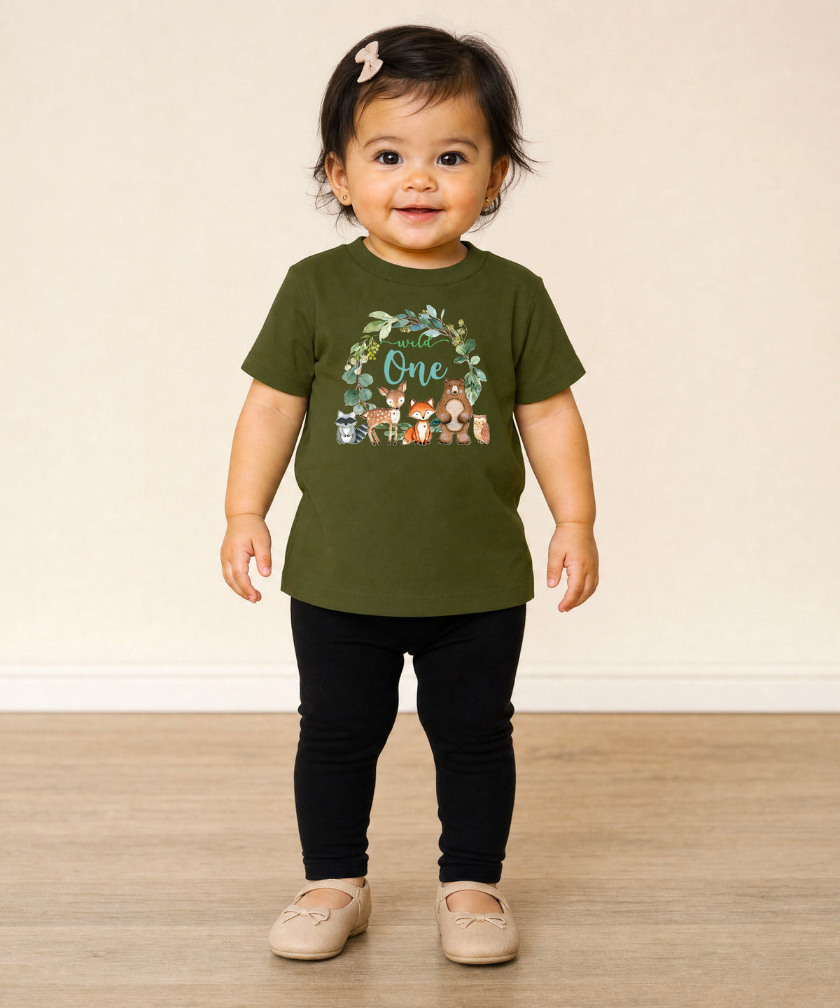 Close-up of Wild One woodland wreath design on military green baby tee