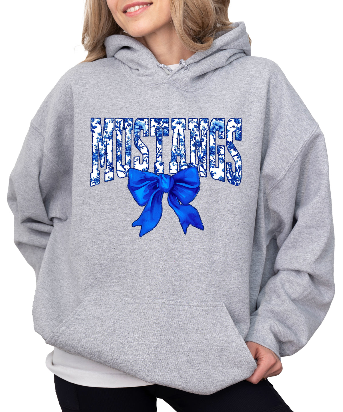 Mustangs floral bow hoodie for women in gray, varsity MUSTANGS letters with blue and white floral print and royal blue bow, image 1