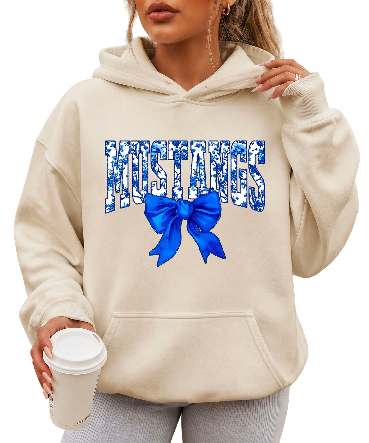 Mustangs floral bow hoodie for women in sand, varsity MUSTANGS letters with blue and white floral print and royal blue bow, image 1