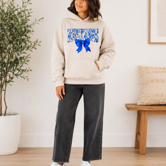 Mustangs floral bow hoodie for women in sand, varsity MUSTANGS letters with blue and white floral print and royal blue bow, image 4