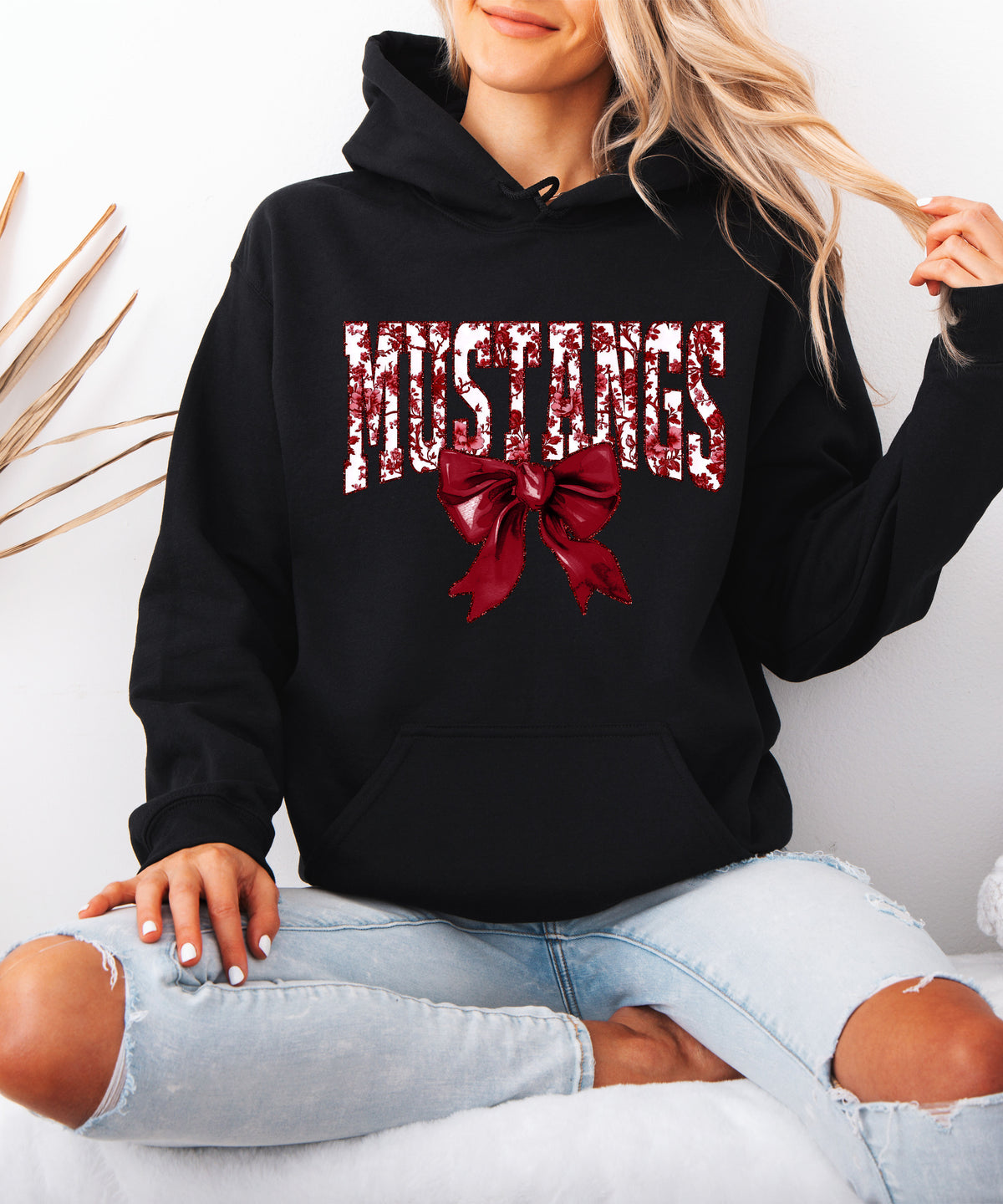 Mustangs floral bow hoodie for women in black, varsity MUSTANGS letters with maroon and white floral print and maroon bow, image 4