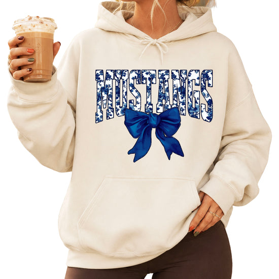 Mustangs floral bow hoodie for women in sand, varsity MUSTANGS letters with navy and white floral print and navy bow, image 1
