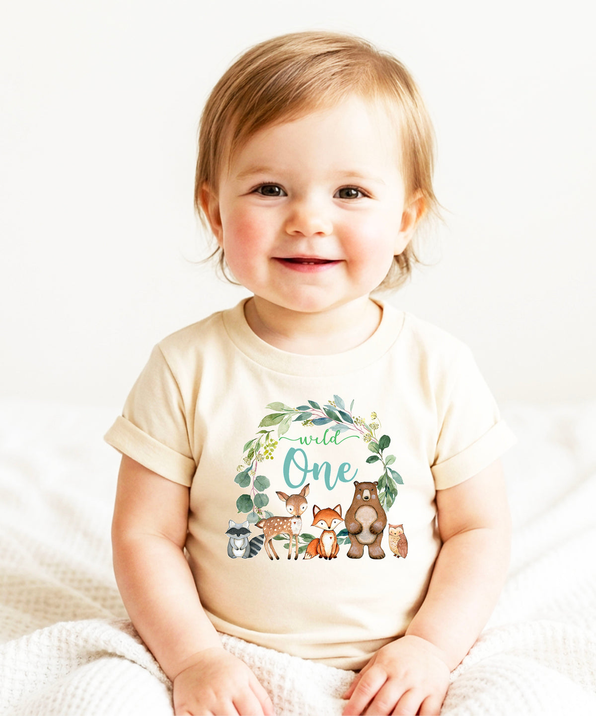 Close-up of Wild One woodland wreath design on natural baby tee