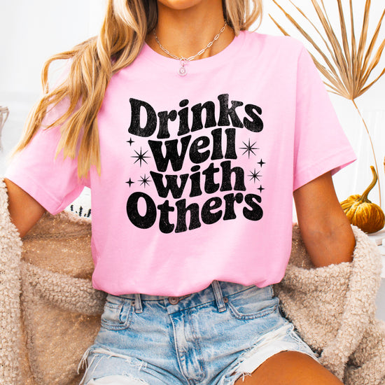 Drinks Well With Others funny graphic tee for women in Pink, detail view
