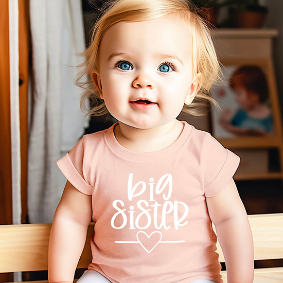 Big Sister heart sibling reveal t-shirt in white on peach, second view