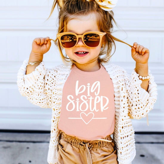 Big Sister heart sibling reveal t-shirt in white on peach, third view