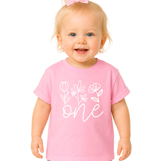 Floral One first birthday shirt for baby girls in pink, front view