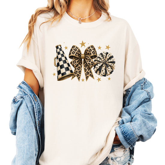 Ivory Comfort Colors 1717 cheer t-shirt with checkered megaphone, leopard print bow and polka dot pom pom graphic, styled view