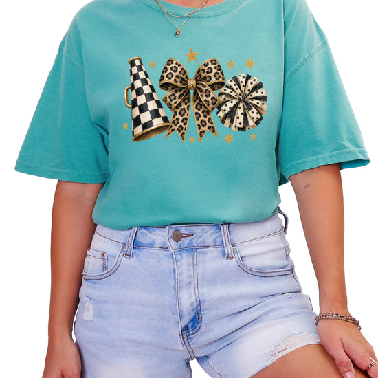 Seafoam Comfort Colors 1717 cheer t-shirt with checkered megaphone, leopard print bow and polka dot pom pom graphic, styled view