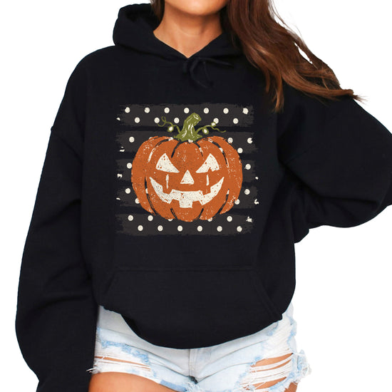 Black hoodie with retro polka dot jack o lantern pumpkin graphic, front view