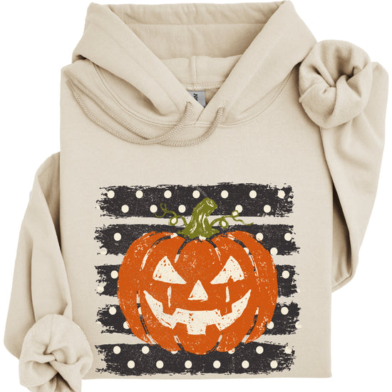 Sand hoodie with retro polka dot jack o lantern pumpkin graphic, close-up of the graphic