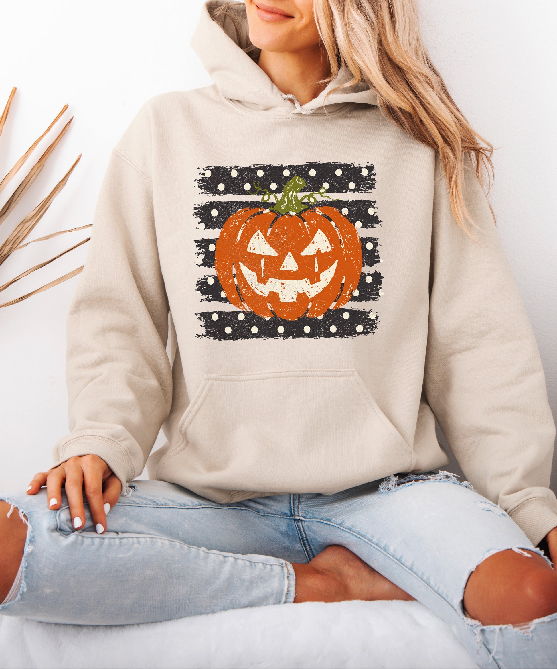 Sand hoodie with retro polka dot jack o lantern pumpkin graphic, detail shot