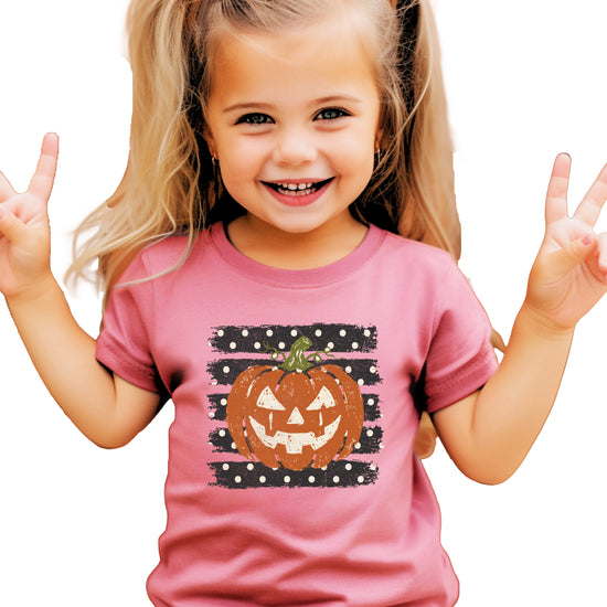 Retro jack-o-lantern pumpkin polka dot Halloween kids tee in Mauve, detail view of the pumpkin graphic
