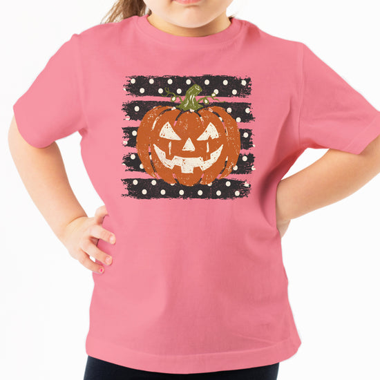 Retro jack-o-lantern pumpkin polka dot Halloween kids tee in Mauve, lifestyle view