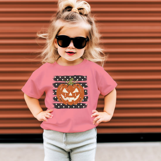 Retro jack-o-lantern pumpkin polka dot Halloween kids tee in Mauve, fit and back view