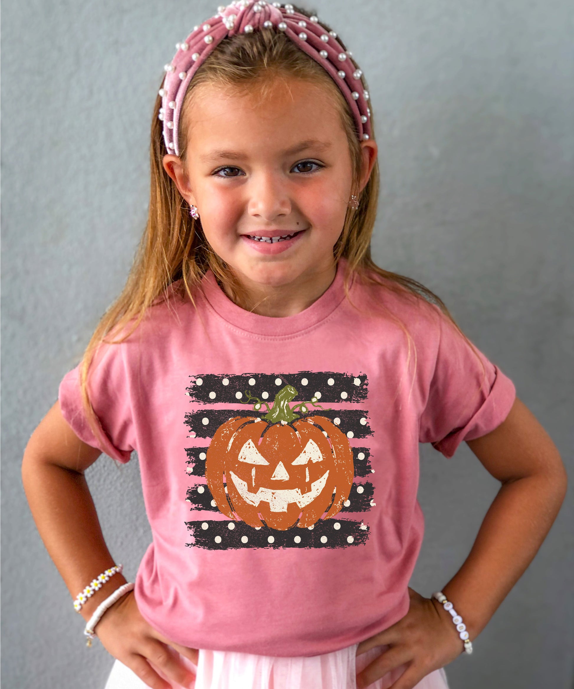 Retro jack-o-lantern pumpkin polka dot Halloween kids tee in Mauve, close-up print detail