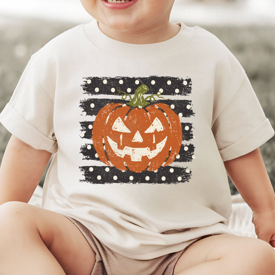 Retro jack-o-lantern pumpkin polka dot Halloween kids tee in Natural, lifestyle view