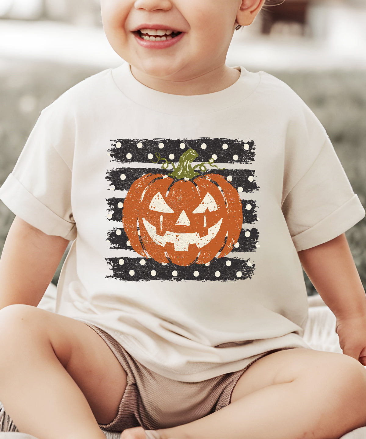 Retro jack-o-lantern pumpkin polka dot Halloween kids tee in Natural, lifestyle view