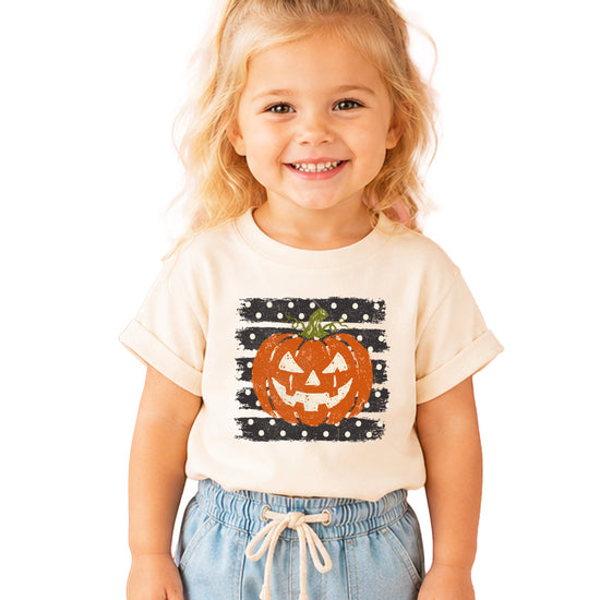 Retro jack-o-lantern pumpkin polka dot Halloween kids tee in Natural, flat lay view