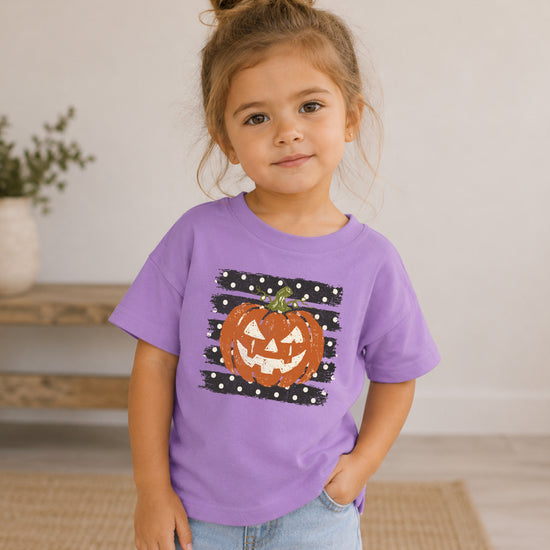 Retro jack-o-lantern pumpkin polka dot Halloween kids tee in Purple, flat lay view