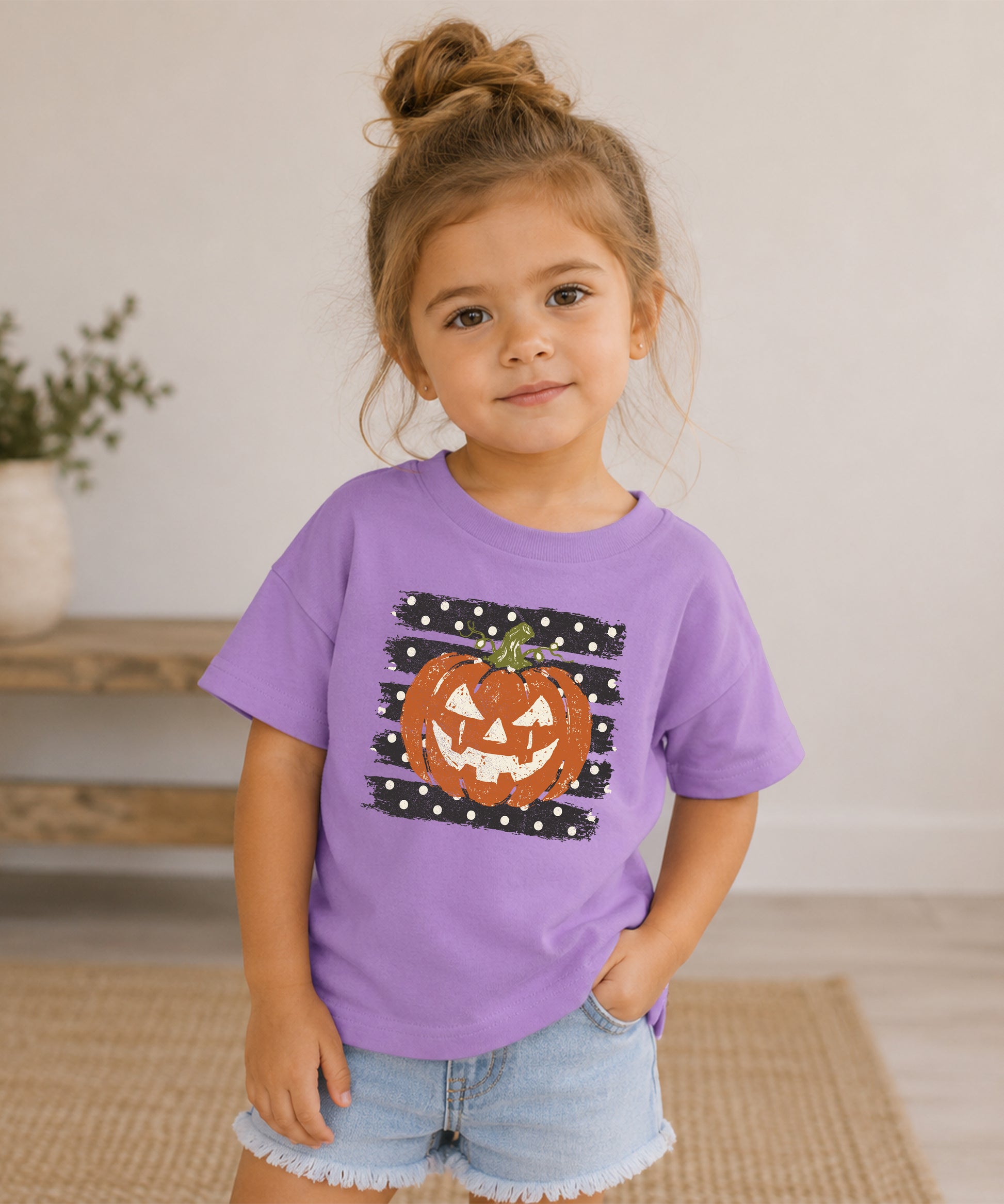 Retro jack-o-lantern pumpkin polka dot Halloween kids tee in Purple, flat lay view