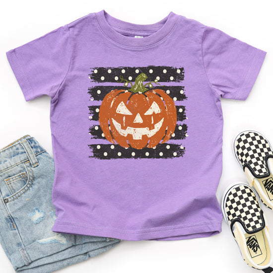 Retro jack-o-lantern pumpkin polka dot Halloween kids tee in Purple, styled view