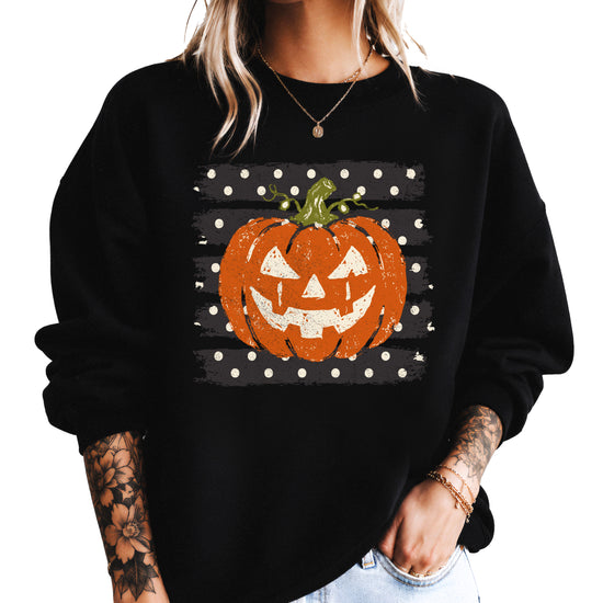 Jack-o-lantern pumpkin polka dot Halloween crewneck sweatshirt in Black, front view