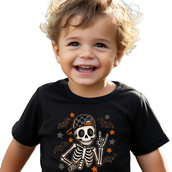 Black skeleton Halloween boys tee with bats and stars, lifestyle shot