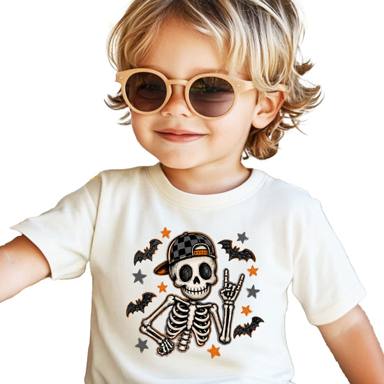 Natural skeleton Halloween boys tee with bats and stars, lifestyle shot