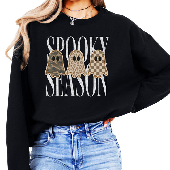 Black Halloween ghost crewneck sweatshirt, close up of camo leopard checkered ghosts