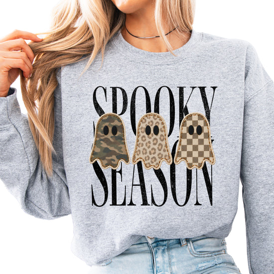 Gray Halloween ghost crewneck sweatshirt, close up of camo leopard checkered ghosts