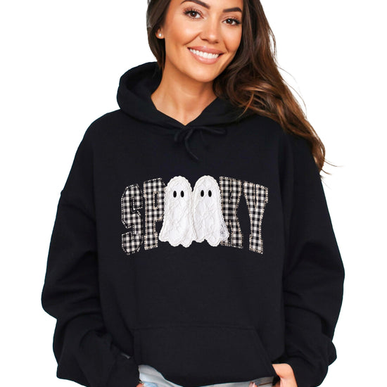Black hoodie with ink-printed spooky ghost gingham check graphic, front view