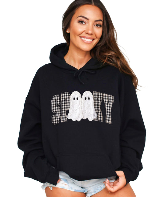 Black hoodie with ink-printed spooky ghost gingham check graphic, front view