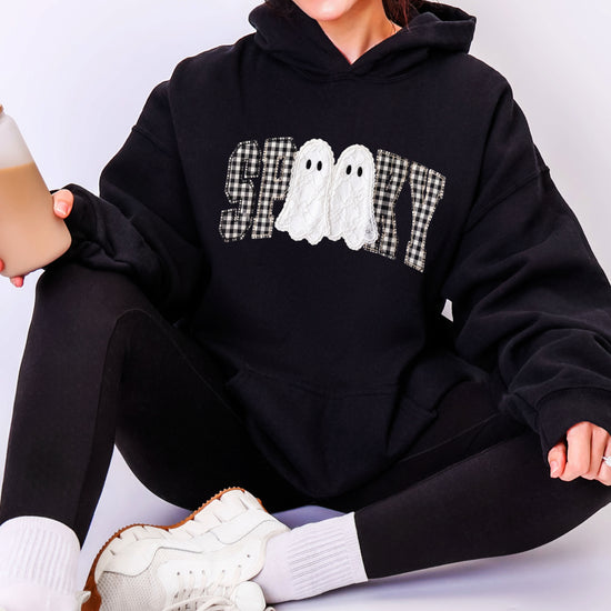Black spooky ghost gingham hoodie close-up of the printed graphic