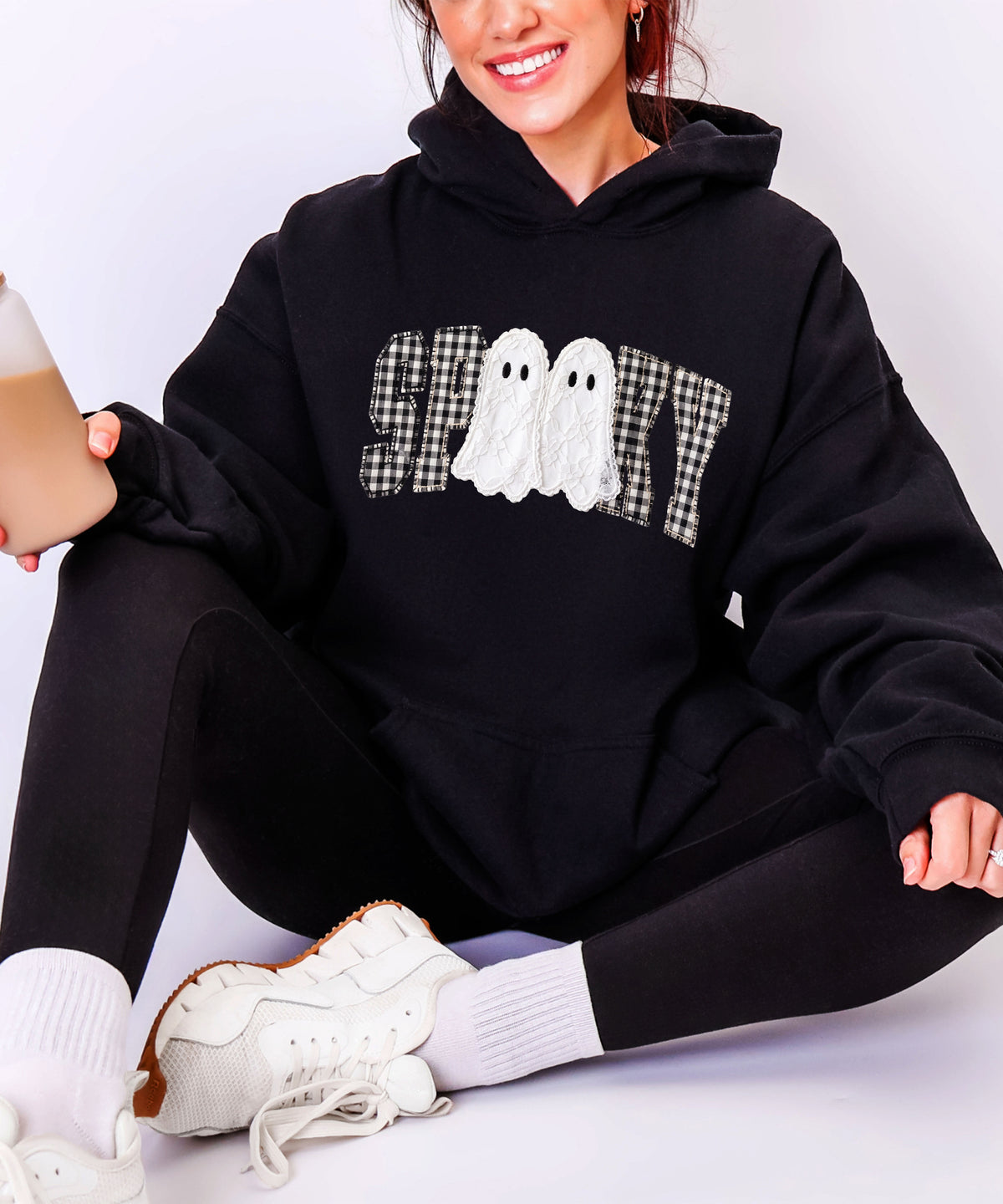 Black spooky ghost gingham hoodie close-up of the printed graphic