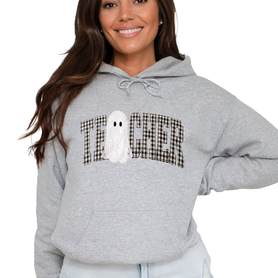 Gray hoodie with ink-printed gingham ghost teacher Halloween graphic, front view