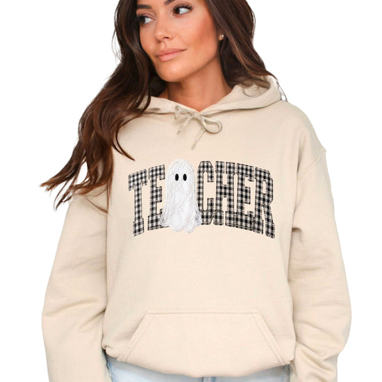 Sand hoodie with ink-printed gingham ghost teacher Halloween graphic, front view