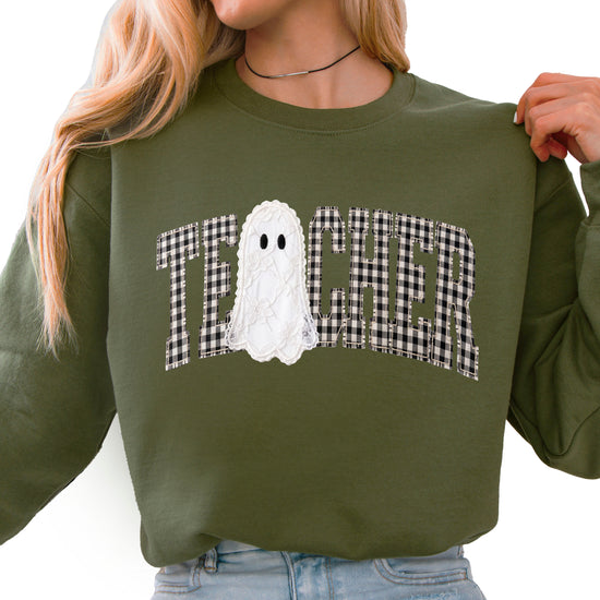 Army green crewneck sweatshirt with ink-printed gingham checkered TEACHER lettering and lace-look ghost, front view
