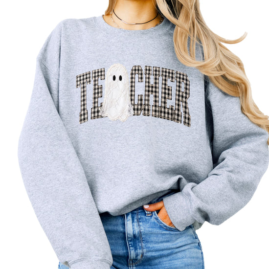 Gray crewneck sweatshirt with ink-printed gingham checkered TEACHER lettering and lace-look ghost, front view